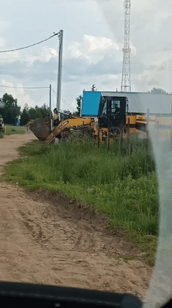 Rural Russia afternoon: construction equipment and dramatic sunset