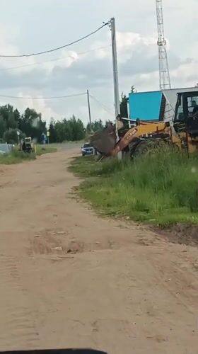 Rural Russia afternoon: construction equipment and dramatic sunset