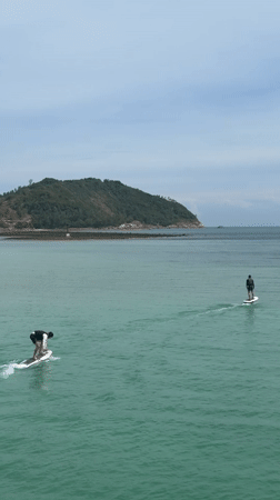 Divers, hydrofoilers, and longtails on a busy Koh Phangan bay