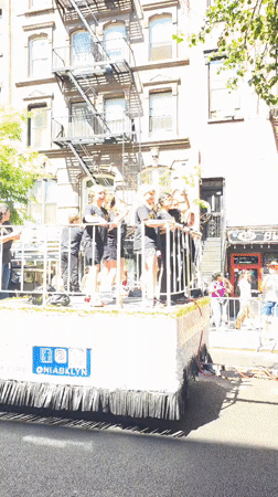 Youth parade float with dancers travels through NYC streets