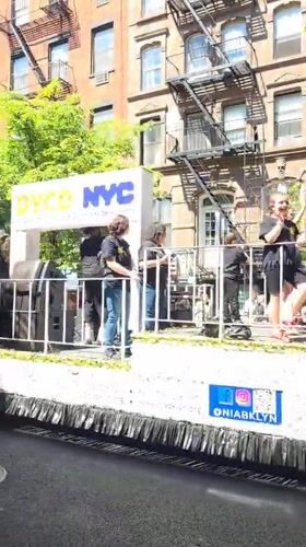 Youth parade float with dancers travels through NYC streets