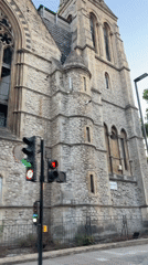 London street pans past historic stone building and pub
