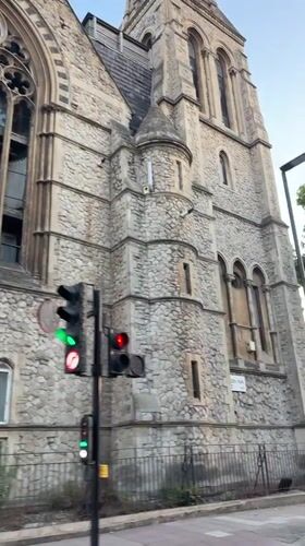 London street pans past historic stone building and pub
