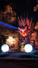 Blue-lit horned statue installation documented at night in Kediri