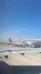 Passenger films aircraft wing and tarmac at Aksu airport