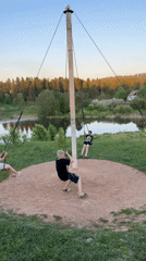 Children play on swings during sunrise in Russian village