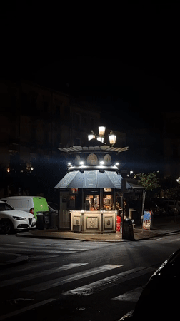 Ornate illuminated kiosk observed at Catania street corner