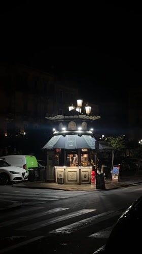 Ornate illuminated kiosk observed at Catania street corner