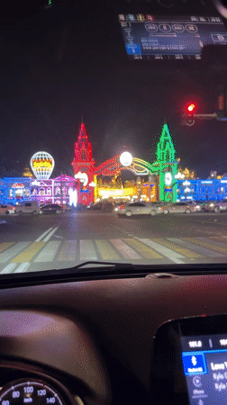 Nighttime drive through Tashkent streets, dashboard in view.