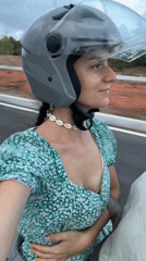 Woman in floral dress rides scooter in Mui Ne