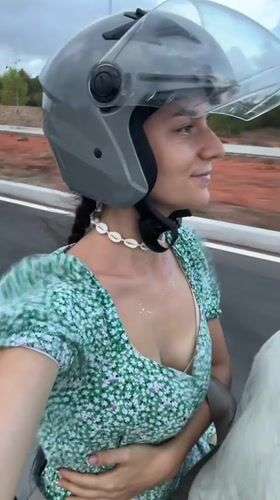 Woman in floral dress rides scooter in Mui Ne