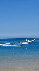 Motorboat pulls inflatable tube in sunny Hurghada waters