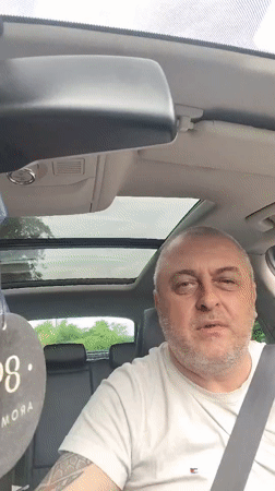 Man makes pointing gestures while seated in car in Clopton