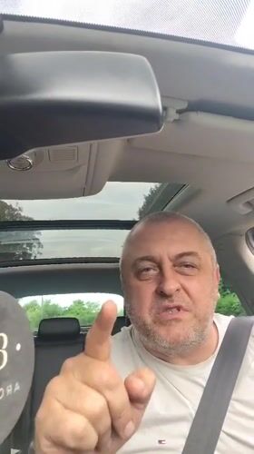 Man makes pointing gestures while seated in car in Clopton