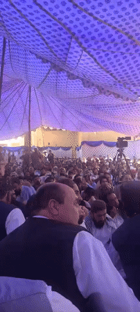 Large outdoor gathering held under tent in Panjpai, Pakistan