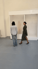 Three people gathered in minimalist Paris studio space