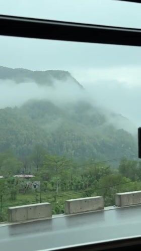Morning fog blankets mountains viewed from vehicle near Pokhara
