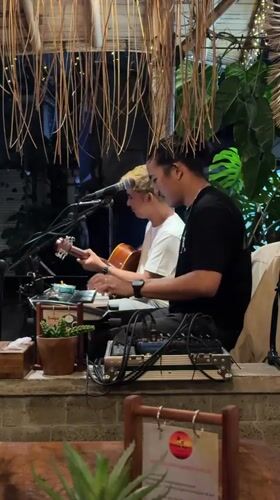 Live acoustic set under a thatched roof in Ubud