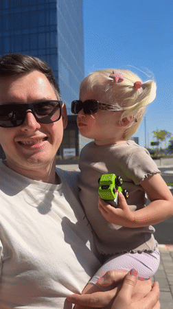 Father and toddler participate in #KissChallenge at Petah Tikva cafe