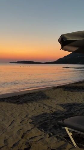 Dusk settles over a quiet beach in Vlichada, Greece