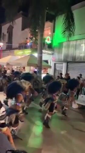 Traditional costume dancers perform nighttime street festival in Arica, Chile