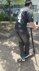 Man performs scooter tricks in Bron park