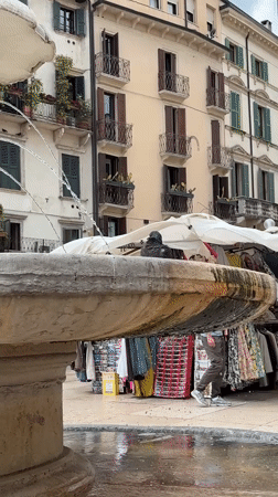 Tourist documents morning stroll through historic Verona city center