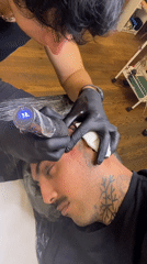 Man gets ear tattoo at Buenos Aires parlor