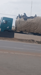 Passenger trucks observed on Nigerian highway near Hayin Banki