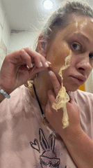 Woman removes facial mask in Perm bathroom
