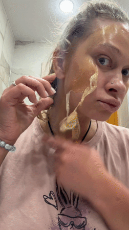 Woman removes facial mask in Perm bathroom