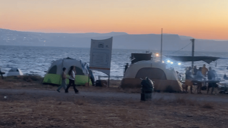 Campers gather at sunset along Sea of Galilee shore
