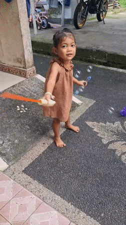 Girl in brown dress recorded standing barefoot in Penebel