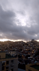 Overcast dusk settles over a Caracas hillside neighborhood