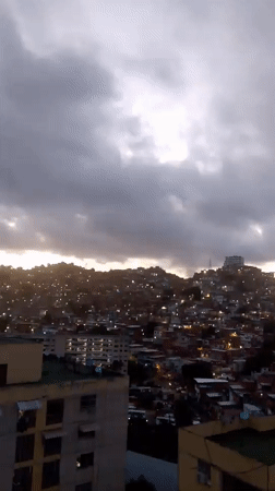Overcast dusk settles over a Caracas hillside neighborhood