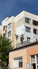 Workers perform facade maintenance on Haskovo building