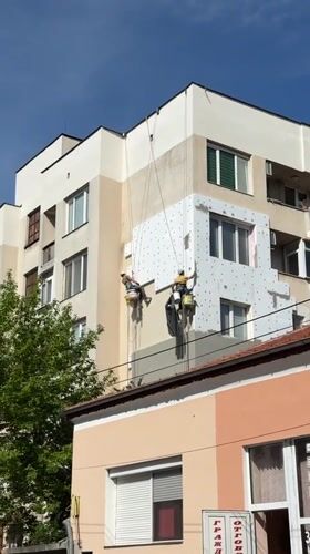 Workers perform facade maintenance on Haskovo building