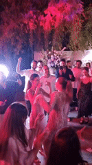 Outdoor nighttime celebration with dancing in Ga'ash, Israel