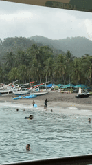 Children play with bodyboards at Senggigi Beach, Indonesia