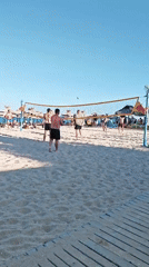Beach volleyball game in full swing on a sunny day