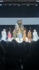 Costumed singers perform with live band in Riga