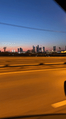Moscow evening commute captures twilight cityscape from highway