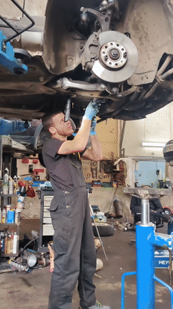 Mechanic services silver car on lift in Sofia repair shop