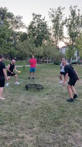 Spikeball game in a Sofia park on a summer afternoon
