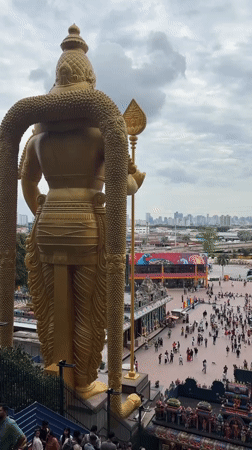 Visitors document morning activities at Malaysia's Batu Caves temple complex