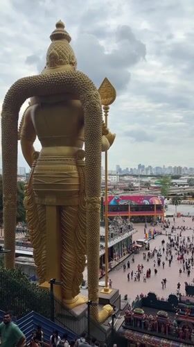 Visitors document morning activities at Malaysia's Batu Caves temple complex