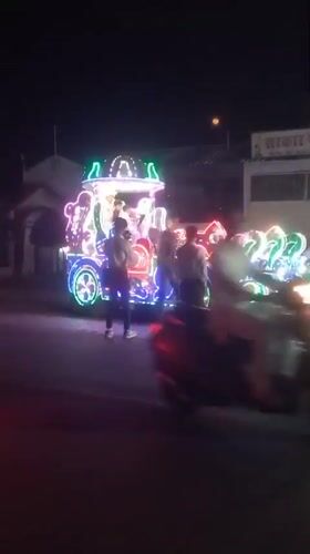 Decorated light-covered vehicle draws crowds on Orai street