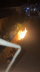 Trash fires burn in concrete ditches in Akwanga, Nigeria