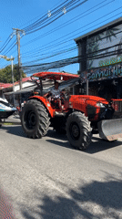 Tractor tows jet skis on road in Thailand