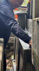 Scrubbing down a stone monument in Kyoto